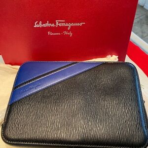 Salvatore Ferragamo mens clutch. New with Tags. Black with blue design.